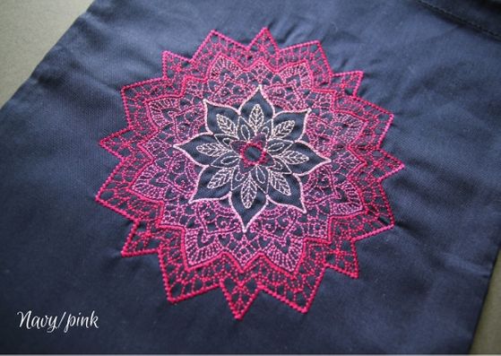 Navy mandala project bag: a close up of a navy cotton bag with a pink mandala fading from a dark outside to lighter inner.