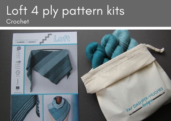 Crochet kit for Loft shawl: on left is a hardcopy of the pattern showing the shawl off in three shades of teal and on the right are the three shades getting darker from right to left, all sat in a rolled back bag with "Fay Dashper-Hughes Designs" embroidered on it.