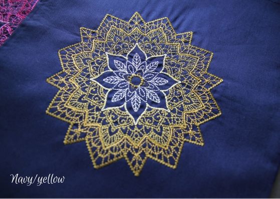 Navy mandala project bag: a close up of a navy cotton bag with a yellow mandala fading from a dark outside to lighter inner.