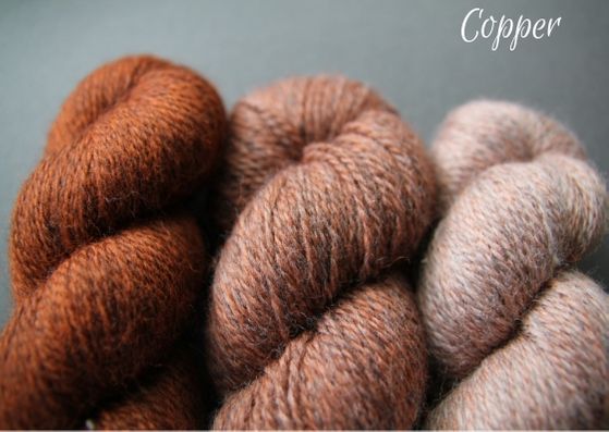 Skeins showing three shades of copper John Arbon Textiles merino 4 ply wool available getting darker from right to left.